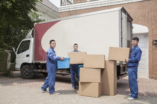 Professional flat removals in Hollandpark with moving boxes in an apartment hallway